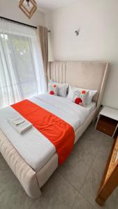 a large bed in a room with a large window at Tusmo homes in Ongata Rongai 