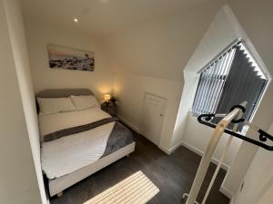 a small bedroom with a bed and a window at 2BR Flat in Prime Location in Hedgerley