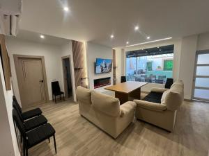 a living room with couches and a dining room table at Casa Jardin Las Eras De Campotejar in Campotéjar