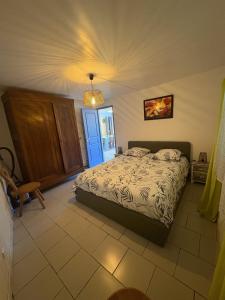 a bedroom with a bed and a blue door at Petite maison au coeur des Hautes-Alpes in Aspres-sur-Buëch
