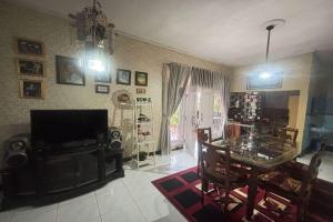 a living room with a table and a dining room at OYO 94841 Alodia Homestay Family in Kejajar