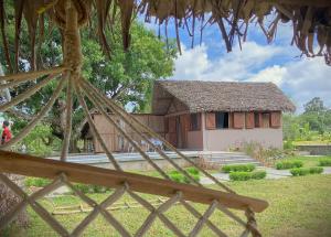 a house with a thatched roof in front of it at Villas Kokoa Serena in Sainte Marie
