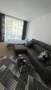 a living room with a couch and a bed at Atlantis Resort in Burgas City
