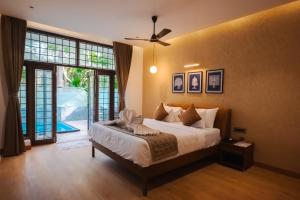 a bedroom with a bed and a ceiling fan at DNC Shevaroys Resorts & Spa in Yercaud