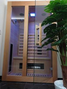 a glass door with a reflection of a building at Perla Sicula in Catania