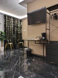 a lobby with a flat screen tv on the wall at Perla Sicula in Catania