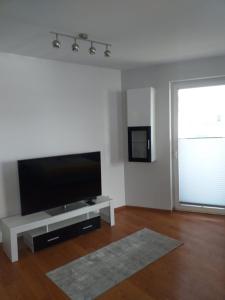 a living room with a flat screen tv on a table at Apartamenty Centrum Studio Zagnańska in Kielce