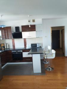 a kitchen with a counter and chairs in a room at Apartamenty Centrum Studio Zagnańska in Kielce +4 photos