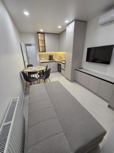 a living room with a table and a kitchen at Truskavets Platinum Apartment 49,50 in Truskavets