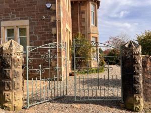 an entrance to a brick building with an iron gate at Ard Solas in Crieff