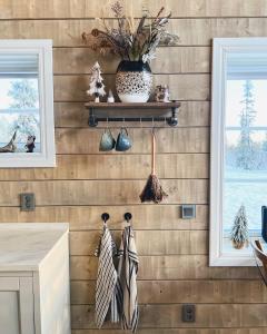 a kitchen with wooden walls with two windows and ties at Large lovely mountain house in Vemdalsskalet in Vemdalen
