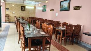 a dining room with long tables and wooden chairs at Blue Pine Resort in Lansdowne