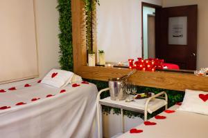 two beds in a room with red hearts on them at Cabecera Country Hotel in Bucaramanga