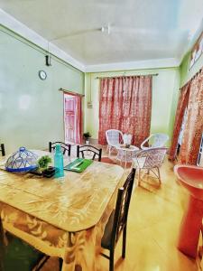 a dining room with a table and chairs in a room at Jonaki Abax Homestay in Nowgong