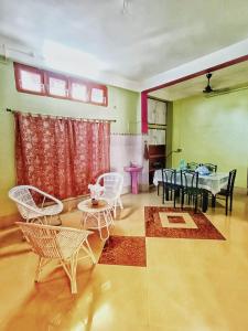 a room with a table and chairs and a dining room at Jonaki Abax Homestay in Nowgong