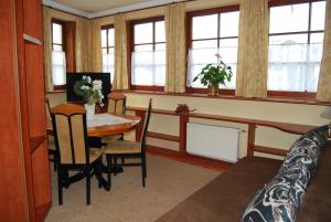 a room with a table and a bed and a dining room at Villa Europa in Mielno