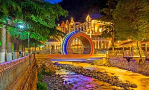 a large building with a lit up facade at night at The Fireplace ROOM in Borjomi
