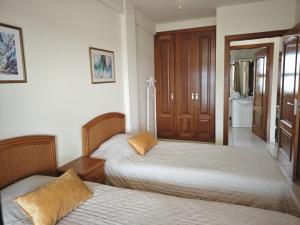 a bedroom with two beds and a bathroom at Big Ocean Terrace - Walk to Las Vistas Beach & Golden Mile in Los Cristianos