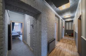 a hallway with a brick wall with a fireplace at Sodų 17 Self Check-in - Lollo Stay in Vilnius