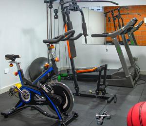 a gym with two exercise bikes and a treadmill at Cabecera Country Hotel in Bucaramanga