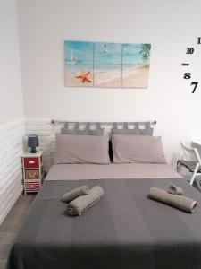 a bedroom with a bed with two towels on it at Studio apartment in the center in Lido di Ostia