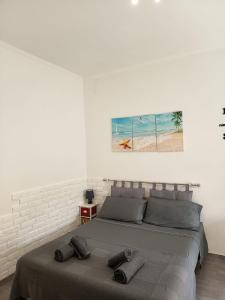 a bedroom with a bed with two pillows on it at Studio apartment in the center in Lido di Ostia +10 photos
