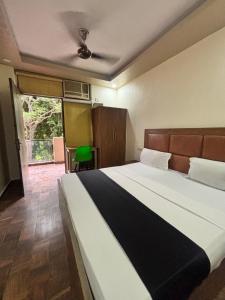 a bedroom with a large bed and a large window at Kerala Homes Near Nizamuddin in New Delhi +17 photos