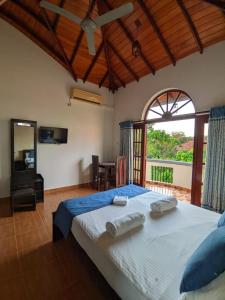 a bedroom with a large bed and a large window at Hotel Transylvania - Negombo in Negombo +72 photos