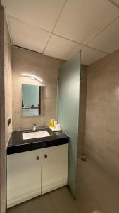 a bathroom with a sink and a mirror at HeavenStay Omaxe Hazratganj in Lucknow