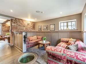 a living room with two couches and a brick wall at The Scotch Arms Mews - Uk30910 in Brampton
