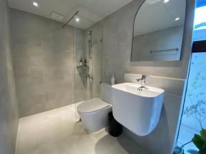 a bathroom with a white toilet and a sink at Stay Sayu Hanok in Gyeongju +43 photos