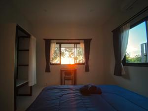 a bedroom with a blue bed and a window at Panoramic Seaview New Bungalow in Salad Beach