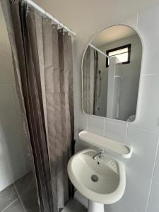 a bathroom with a sink and a mirror at Panoramic Seaview New Bungalow in Salad Beach