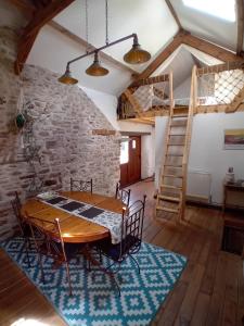 a dining room with a wooden table and chairs at The Barn Square Island in Pembroke +6 photos