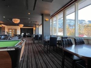 a conference room with pool tables and chairs at Hakuba Echo Hotel and Apartments in Hakuba