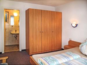a bedroom with a bed and a cabinet and a sink at Apartment Kristall-1 by Interhome in Fendels +14 photos