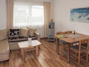 a living room with a couch and a table at Apartment Kristall-2 by Interhome in Fendels +18 photos