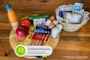 a cutting board with some food on a table at Apartamenty Centrum Park Sowińskiego 19 in Zielona Góra +47 photos