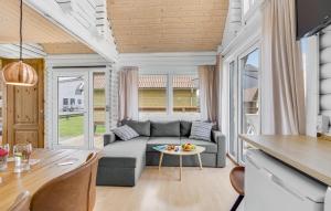 a living room with a couch and a table at Awesome Home In Tranekær in Tranekær