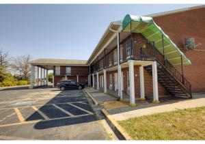 a building with a staircase on the side of it at Capital O First Heritage Inn Rantoul IL I 57 in Rantoul