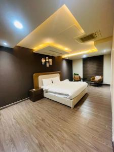 a bedroom with a large white bed in a room at Luxury suites in Lahore