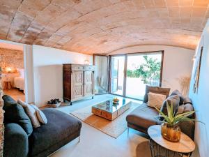 a living room with a couch and a table at Mas Oms in Montnegre +38 photos
