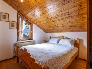 a bedroom with a bed and a wooden ceiling at Apartment Oga Mountain Home by Interhome in Oga