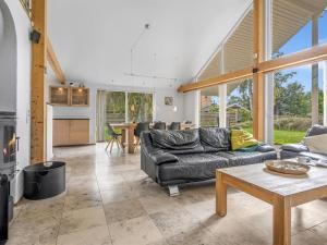 a living room with a couch and a table at Holiday Home Talitha - 40m from the sea by Interhome in Marielyst +16 photos