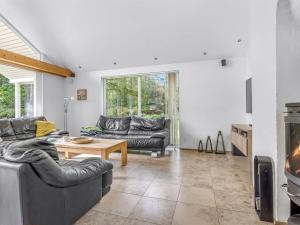 a living room with two couches and a fireplace at Holiday Home Talitha - 40m from the sea by Interhome in Marielyst