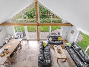 a living room with a couch and a table at Holiday Home Talitha - 40m from the sea by Interhome in Marielyst