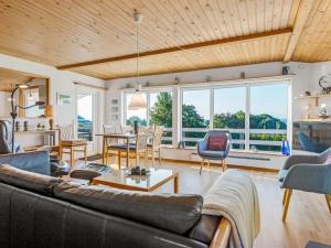 a living room with a couch and chairs at Holiday Home Senni - 800m from the sea by Interhome in Rønsheved