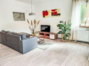 a living room with a couch and a tv at Apartment Sonnenblick by Interhome in Amelunxen +22 photos