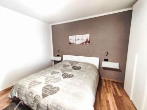 a bedroom with a bed with a heart blanket at Apartment Festér by Interhome in Santi di Daone