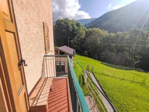 a balcony of a building with a view of a field at Apartment Festér by Interhome in Santi di Daone +32 photos